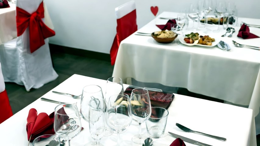 Mesas del restaurante decoradas con servilletas en forma de corazón para eventos románticos
